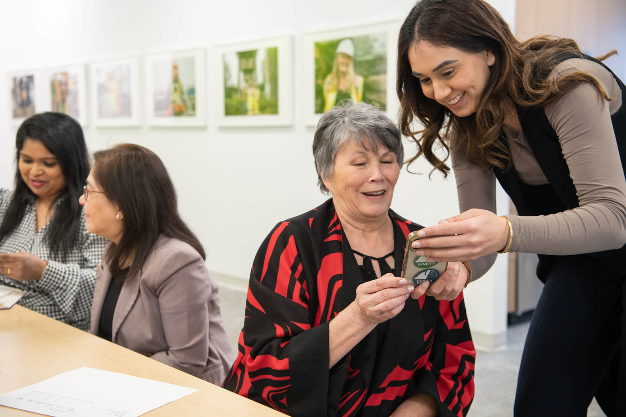 Two people looking at a phone smiling