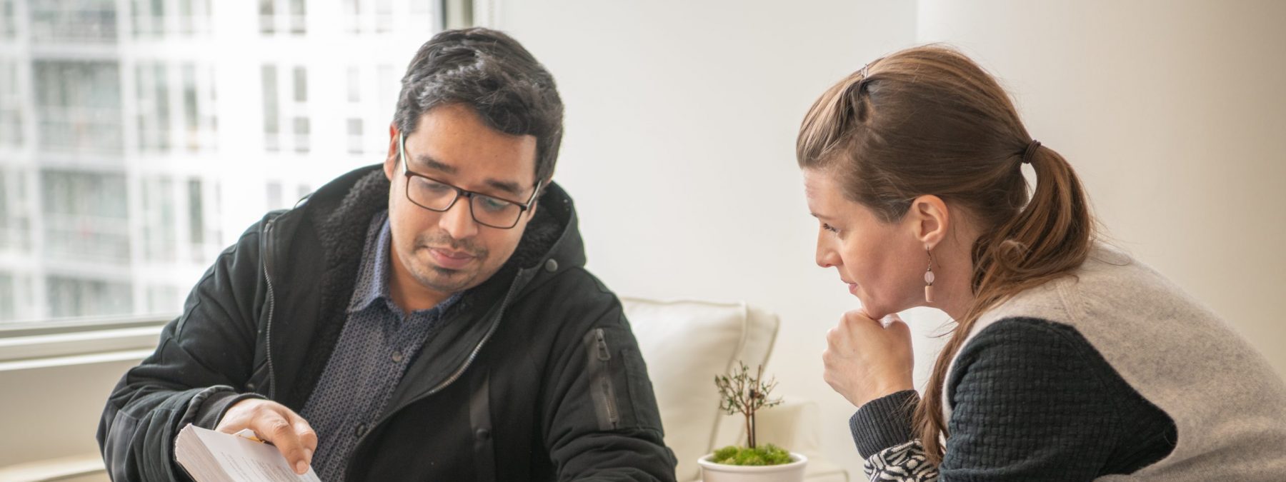 Two BCIB employees named Jeff and Pham looking at a document