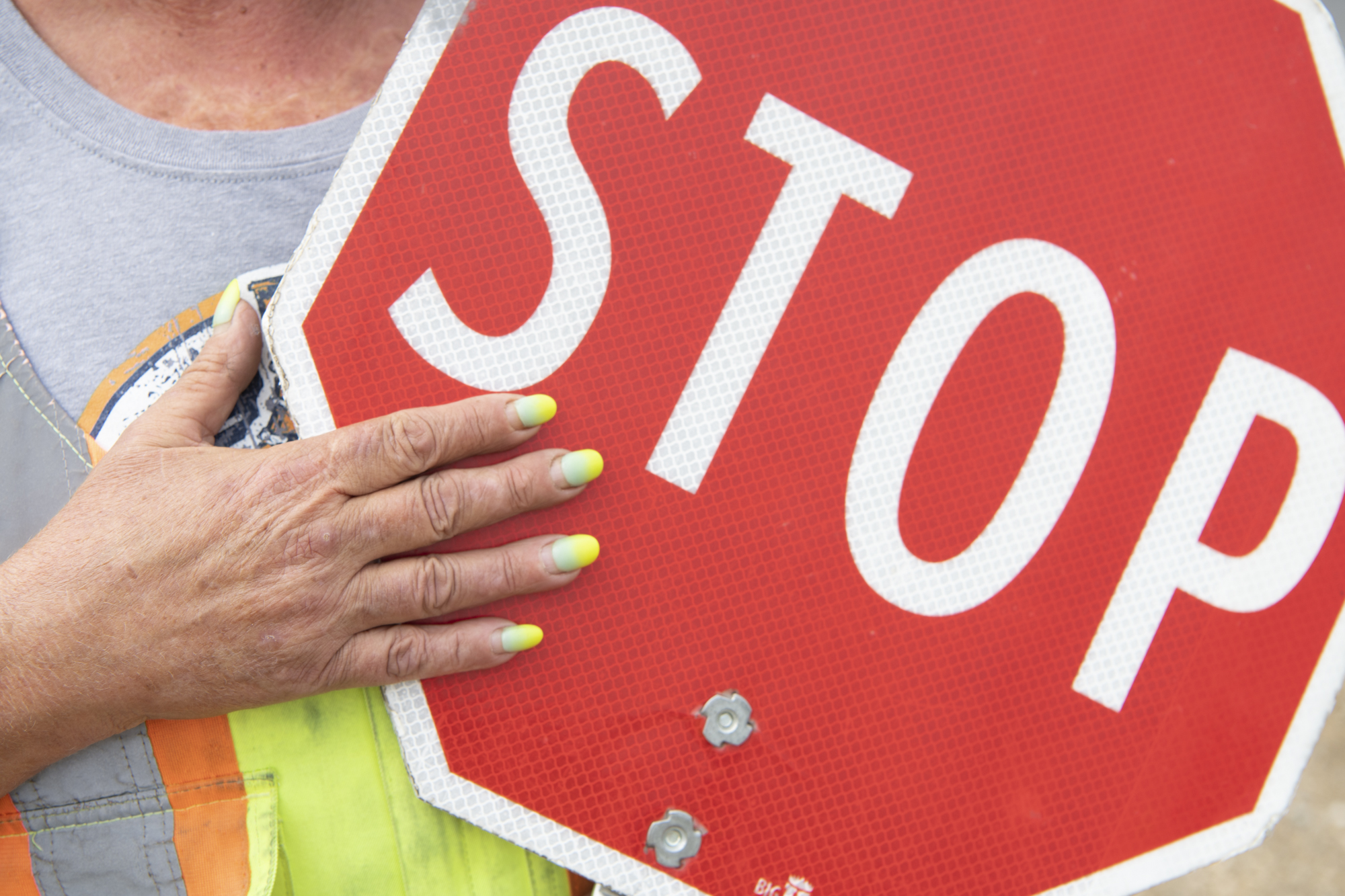 An image of a hand and a stop sign.