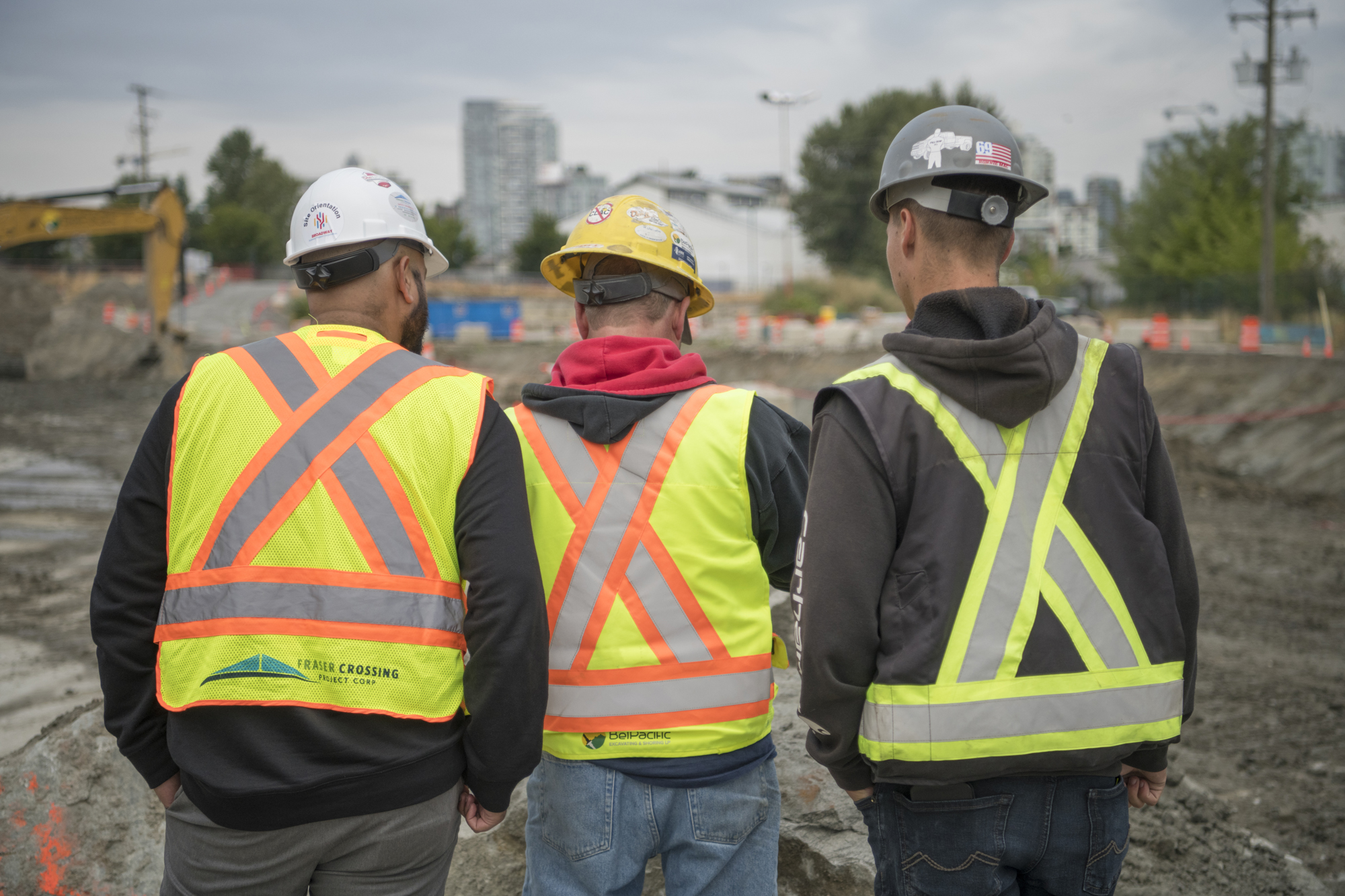 An image of 3 men with backs to the camera